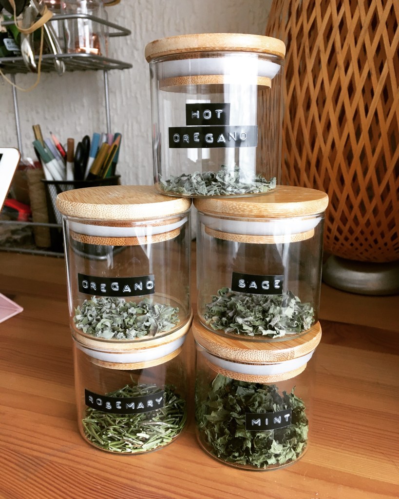 5 labelled jars of dried herbs