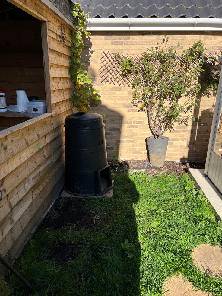 Shot of the compost bin in the corner of the garden
