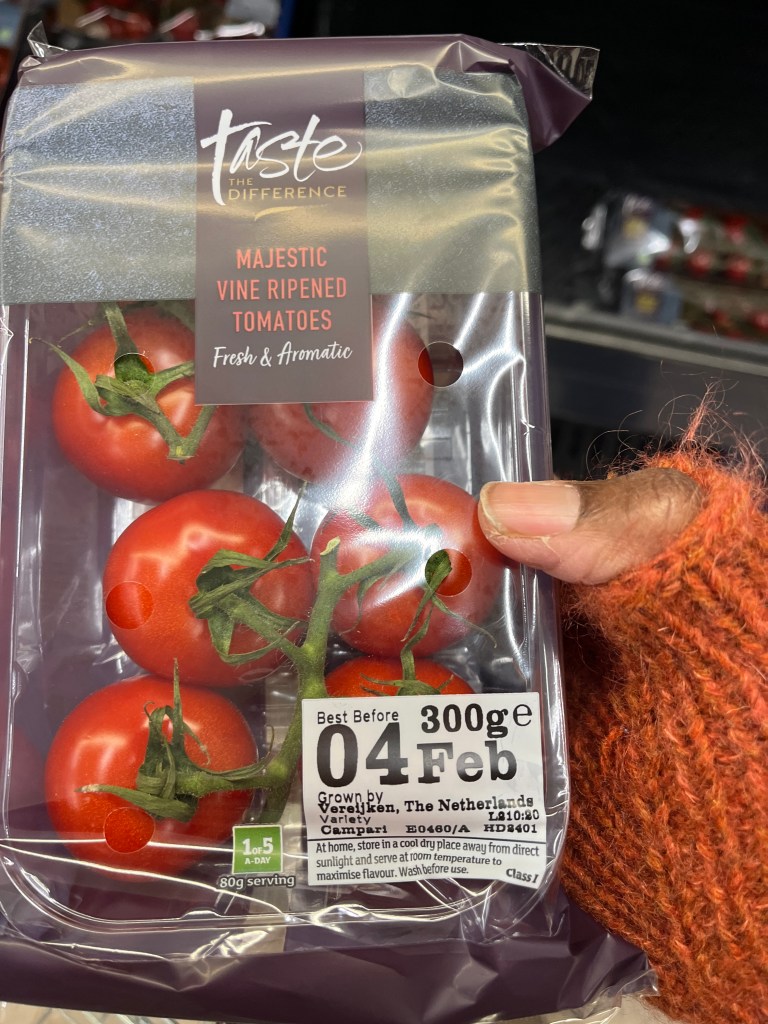 A packet of Sainsbury's "Taste the Difference" vine tomatoes in the supermarket.